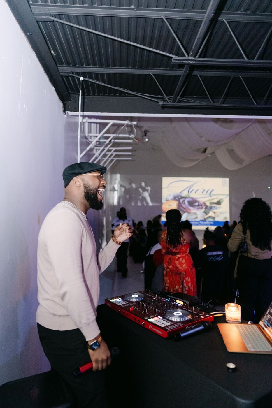 Self smiling beside his DJ controller at a live event